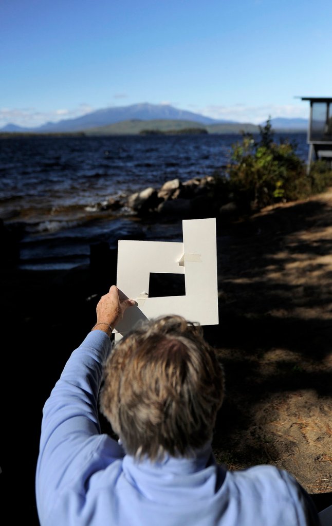 Sandra Pye of Phippsburg frames Katahdin before beginning to paint.