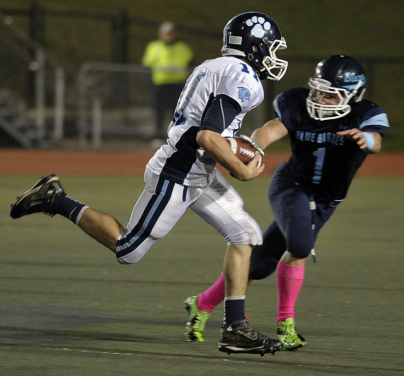 Mark MacGlashing of York attempts to find room around Ben Grant of Westbrook. The teams were tied atop the Crabtree standings entering the game.