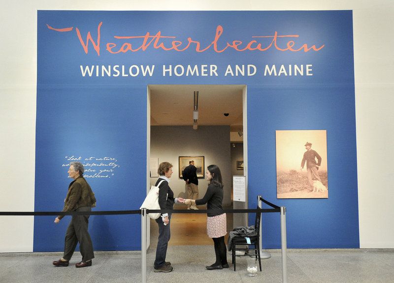 Anna Schember, right, collects a ticket Friday from one of the estimated 75,000 people who are expected to visit the Winslow Homer exhibition at the Portland Museum of Art.