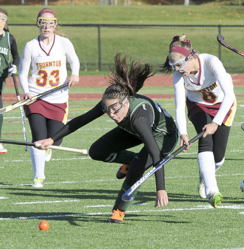 Cassidy Merrill of Bonny Eagle is tripped Saturday while competing with Libby Pomerleau of Thornton for the ball. At left for Thornton is Karen Jacques. Thornton won, 2-0.