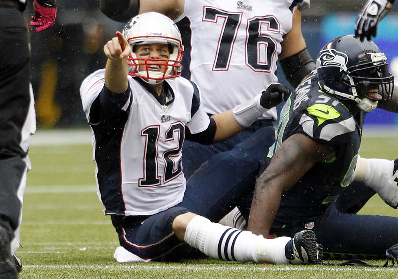 Tom Brady points to an official after being penalized for intentional grounding at the end of the first half Sunday. The penalty cost the Pats a chance at some points.