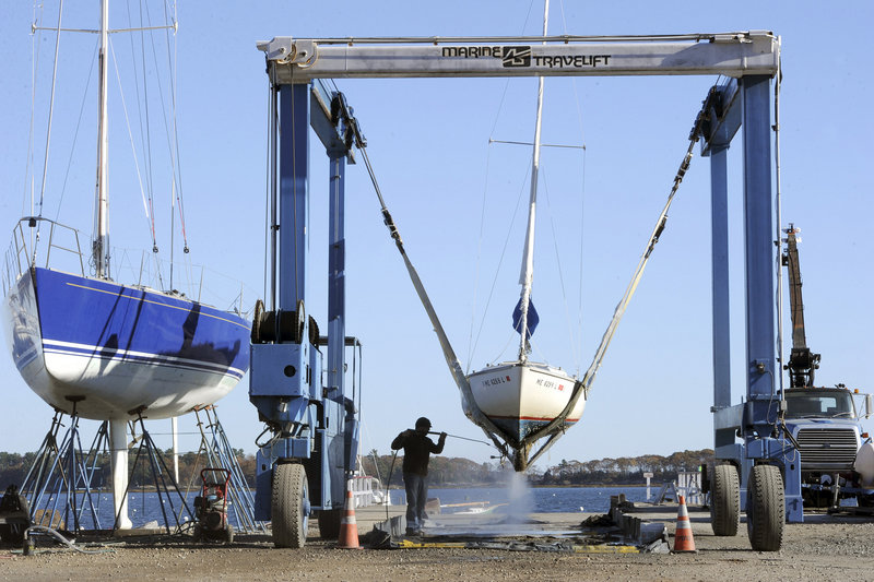 James Cullum of Handy Boat in Falmouth power washes one of 30 boats he planned to haul out in anticipation of the hurricane that was barreling up the Eastern Seaboard on Thursday. The storm’s effects are expected in Maine next week.