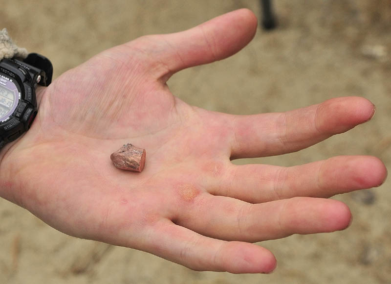 Kennebec County Sheriff Dept. Sgt. Chris Cowan. hold the smashed .45-caliber, 230-grain slug that struck the sheriff. Cowan said a bullet from a .45 caliber pistol can travel more than 800 feet per second.