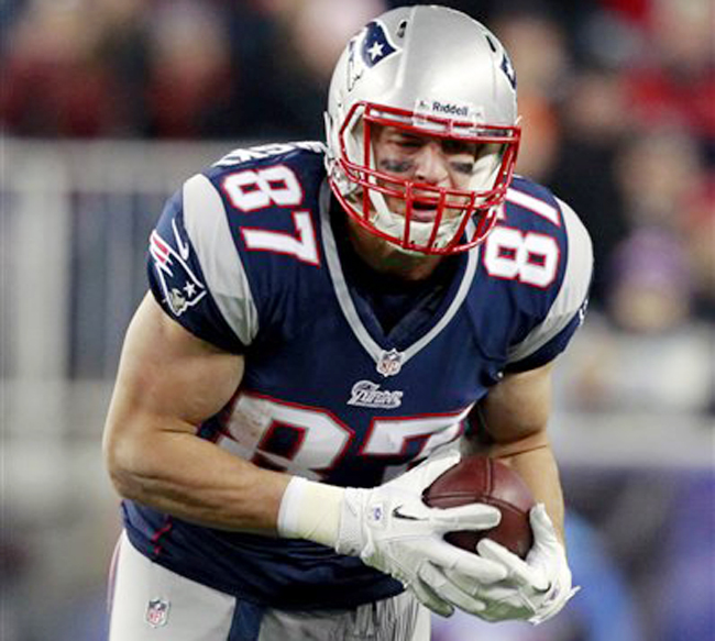 New England Patriots tight end Rob Gronkowski carries the ball for extra yardage in Sunday's game against the Indianapolis Colts in Foxborough, Mass. Gronkowski left the game in the fourth quarter with an arm injury.