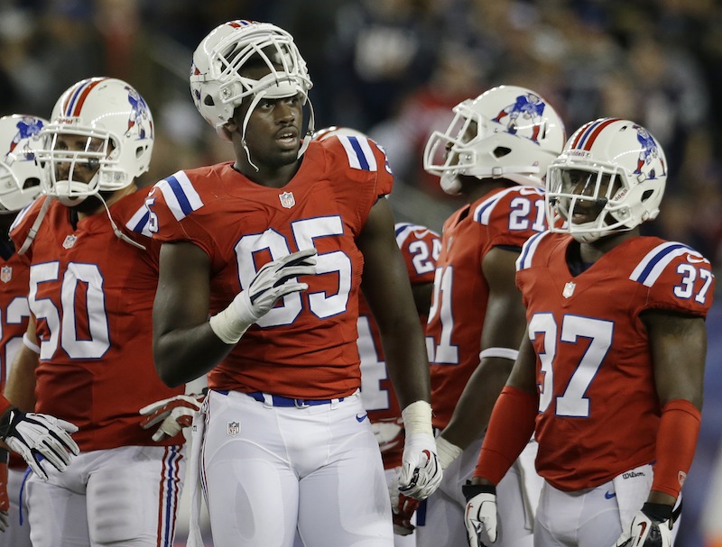 New England Patriots defensive end Chandler Jones (95) waits on the field with his teammates during a break in an NFL football game against the New York Jets in Foxborough, Mass. Sunday, Oct. 21, 2012. (AP Photo/Elise Amendola) Gillette Stadium