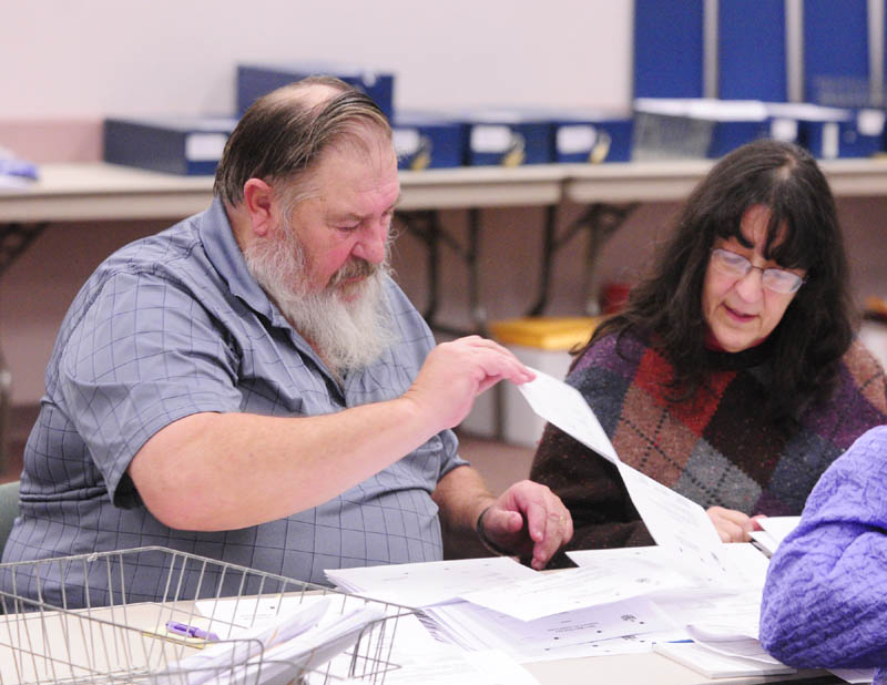 Volunteer counters Carl Pettengill, of Farmingdale, left, and Rita Moran, of Winthrop, sort through ballots in the House District 80 race between Republican incumbent Rep. Melvin Newendyke and Democratic challenger Rachel Sukeforth.