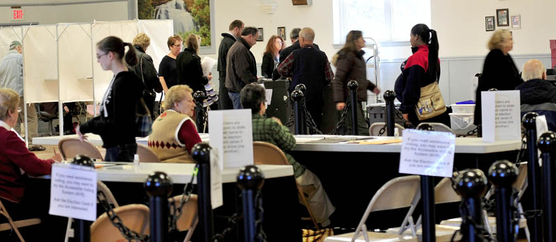 Waterville voters check in with ward clerks, in foreground, as others wait in line to cast their votes in machines at the busy American Legion Hall on Tuesday. There was concern earlier that a ballot counting machine had malfunctioned but was quickly restored, according to City Clerk Patty Dubois.
