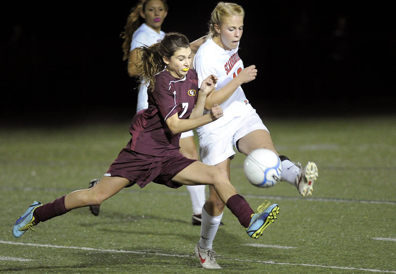 Kathryn Cook of Cape Elizabeth, left, tries to edge out Maria Philbrick of Scarborough for possession in the second half Wednesday.