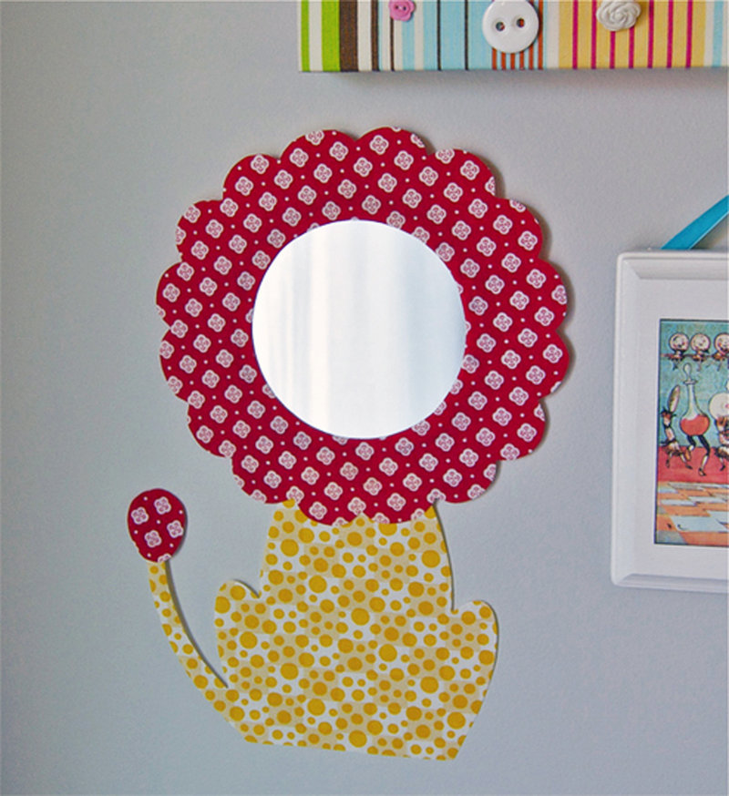 I am baby, hear me roar: Fabric frames a nursery mirror, creating a darling lion motif.