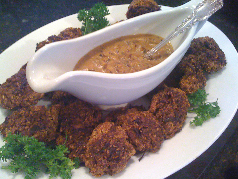 Pumpkin seed croquettes surround shiitake mushroom gravy.