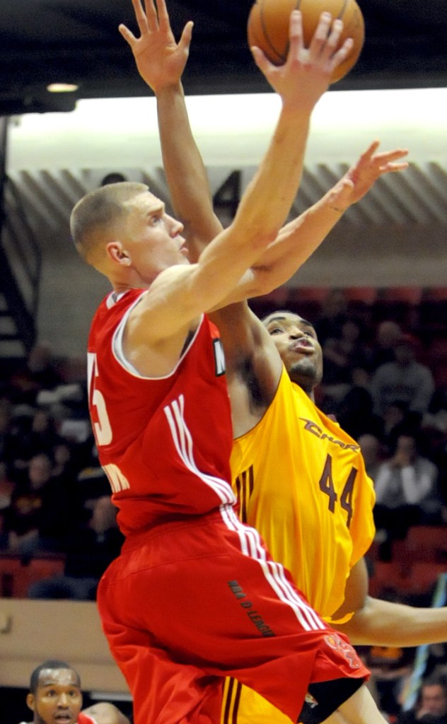 Micah Downs, the former Gonzaga player now with the Red Claws, powers his way to the basket, driving against Kevin Jones, the former West Virginia player now with Canton.