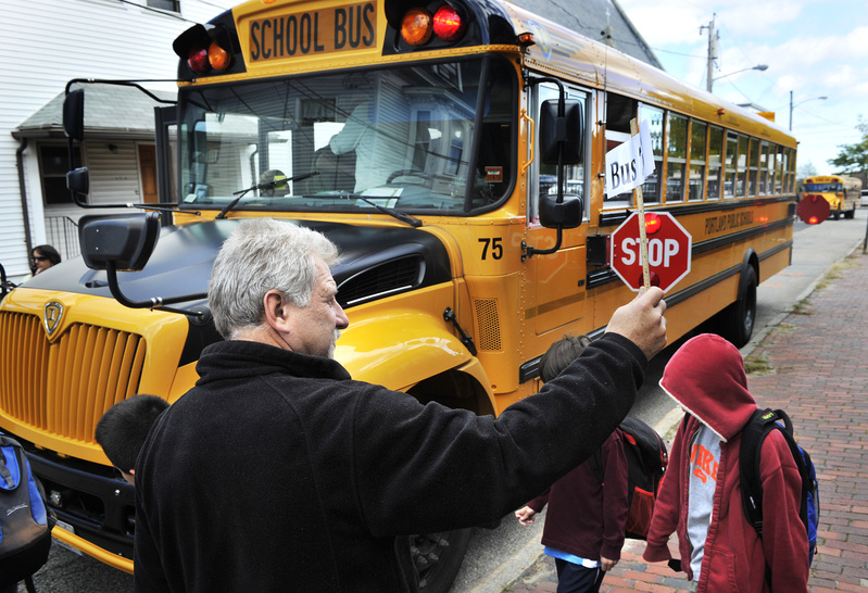 Portland school buses board students from the Hall Elementary School in October. The school board is seeking $46 million in renovations to five Portland elementary schools, including Hall.