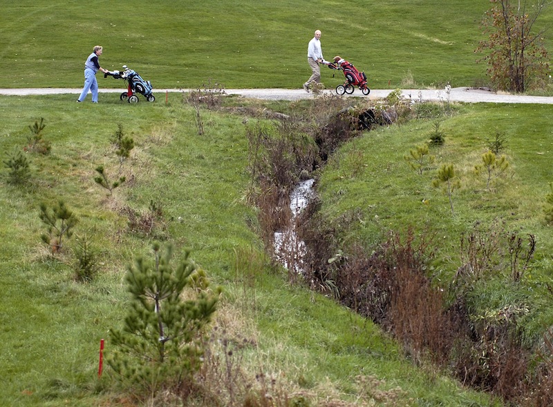 In this November 2007 file photo, Judy and Gerry Ducharme of Falmouth play golf at Riverside Golf Course in Portland. The city-owned Riverside Golf Course should be operated by a private company through a lease with the city, or Portland should invest its own money to improve the course and keep it a public entity, says a consulting firm hired by the city.