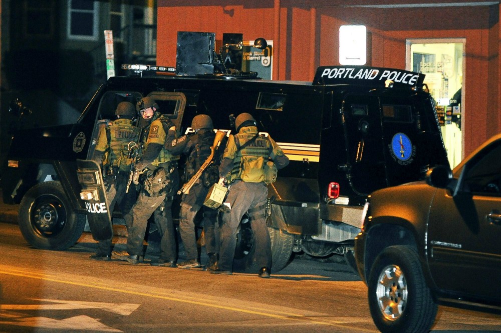 Thursday, December 22, 2011. The Portland Police Special Reaction Team members start their movement outside the Lock, Stock and Barrel toward the apartment building containing the suspect who is with a stand off with police on St. John Street.