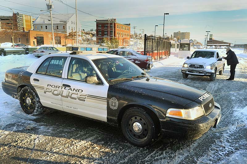 Portland residents retrieve their cars from the city's impound lot on Friday, Dec. 28, 2012, after having them towed during the recent snow storm. A Portland police officer releases a vehicle from the impound lot on Commercial Street.