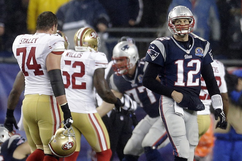 New England Patriots quarterback Tom Brady (12) walks toward the sideline in the second quarter of an NFL football game against the San Francisco 49ers in Foxborough, Mass., Sunday, Dec. 16, 2012. (AP Photo/Elise Amendola) NFLACTION12; Gillete Stadium