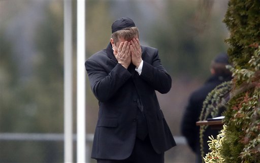 A mourner arrives at the funeral service for 6-year-old Noah Pozner in Fairfield, Conn., on Monday. Pozner was one of 26 people killed in Friday's mass shooting.