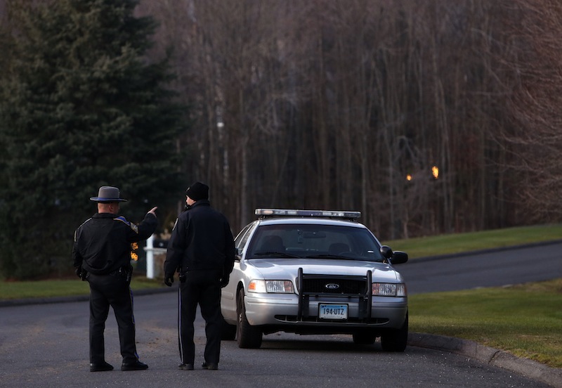 Police block off a section of Yogananda Street near a house belonging to the mother of a man who opened fire inside a Connecticut elementary school, killing 26 people, including 18 children, Friday, Dec. 14, 2012 in Sandy Hook, Conn. (AP Photo/Jason DeCrow)