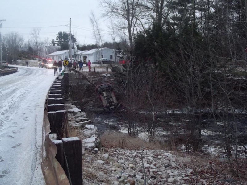This photo provided by the Lebanon Rescue Department's Facebook page shows an SUV that smashed through a guardrail Christmas morning and settled on a riverbank. The driver escaped injury.