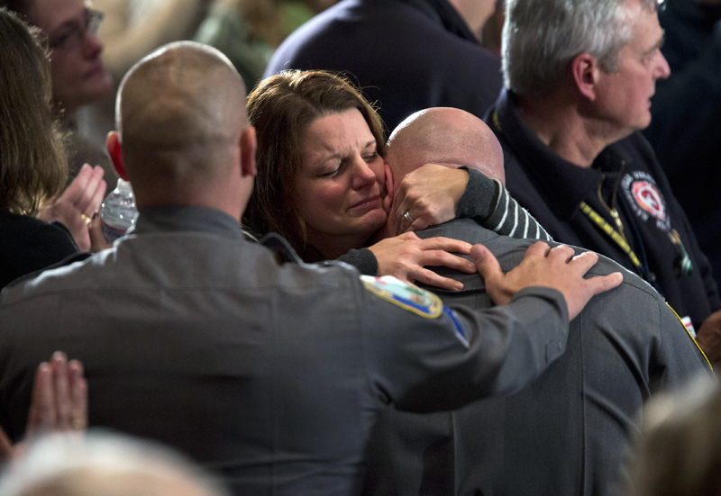 Residents greet each other Sunday before the start of an interfaith vigil for the victims of the Sandy Hook Elementary School shooting. The vigil was being held at Newtown High School in Newtown, Conn.