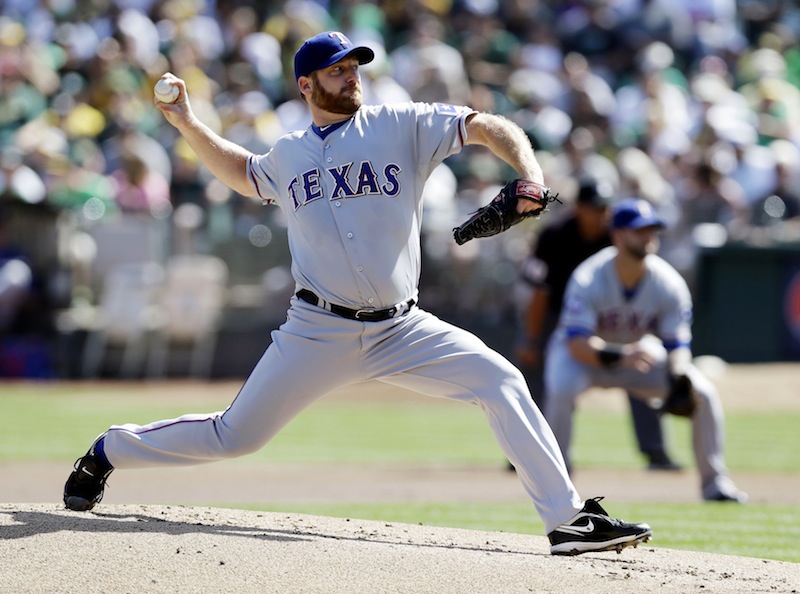 This Oct. 3, 2012 file photo shows Texas Rangers starting pitcher Ryan Dempster throwing against the Oakland Athletics during the first inning of a baseball game in Oakland, Calif. Two people familiar with the negotiations say the Boston Red Sox have agreed to a $26.5 million, two-year contract with Dempster. The people spoke on condition of anonymity Thursday, Dec. 13, 2012, because the agreement is pending a physical. (AP Photo/Marcio Jose Sanchez, File)