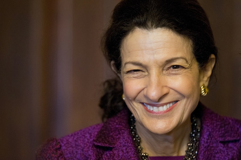 Snowe smiles while taking photographs with members of her staff after delivering her farewell speech to the Senate on Thursday.