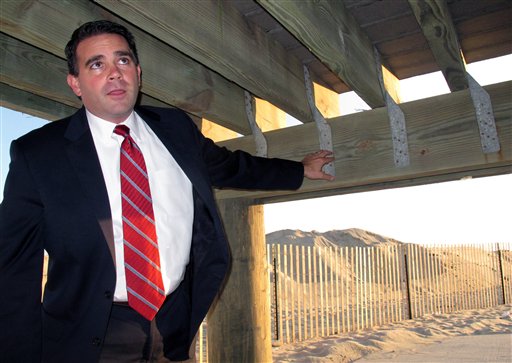 Belmar, N.J., Mayor Matthew Doherty points to hurricane tie-down straps under the one tiny section of boardwalk in his community that survived Superstorm Sandy. The borough used the straps in an experimental section to see if it withstood storm damage better than normal boardwalk construction. Belmar is spending $20 million to rebuild its boardwalk, and will use the tie-down straps on the entire new project.