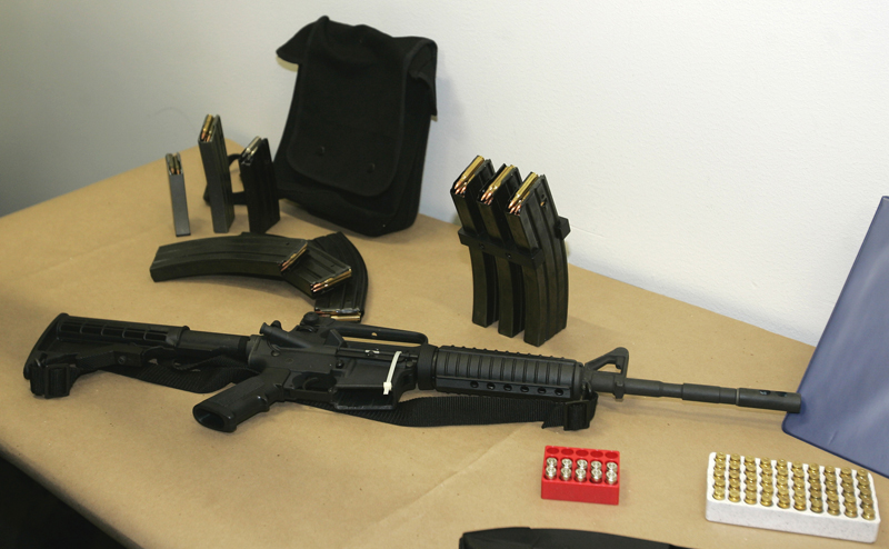This March 27, 2006, file photo shows a Bushmaster AR-15 semi-automatic rifle and ammunition on display at the Seattle Police headquarters in Seattle.