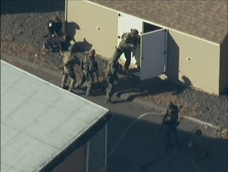 Police search a building after the shooting at Sandy Hook Elementary School in Newtown, Conn., on Friday. President Obama struck the right tone with his remarks Friday: "We are going to have to come together and take meaningful action, regardless of the politics."