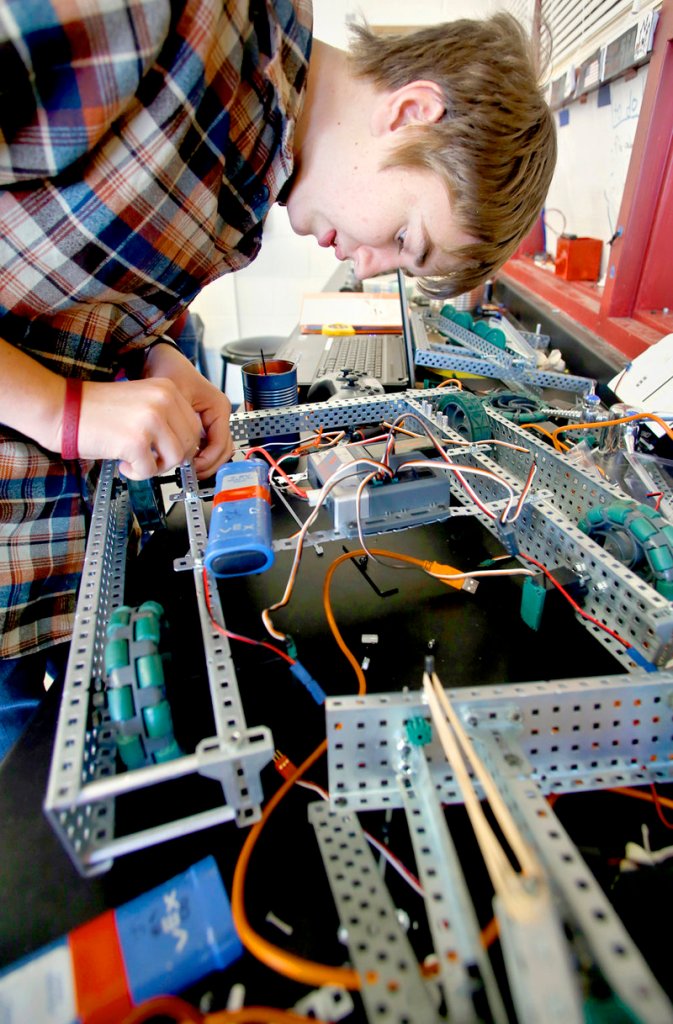 Walker Grimes, 15, a sophomore, works on his robot as he along with other members of the Cape Robotics Club prepare for the third annual Southern Maine VEX Robotics Tournament at Cape Elizabeth High School on Friday.