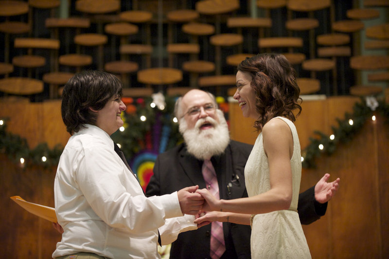 Jessica Lee, 19, left, and Ashley Cavner, 21, both of Vancouver, Wash., complete their wedding vows shortly after midnight Saturday in Clark County, Wash.