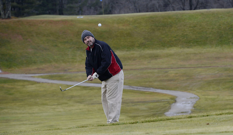 Mark McCarthy of Portland watches a chip shot go onto the green on the 7th hole at Riverside Golf Course in Portland on Thursday, Dec. 11, 2012.