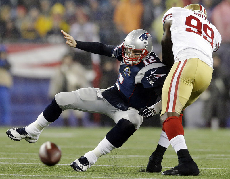 San Francisco’s Aldon Smith forces an incomplete pass by Tom Brady during Sunday’s game in Foxborough. The Patriots dropped to third in the AFC playoff race with a 41-34 loss.