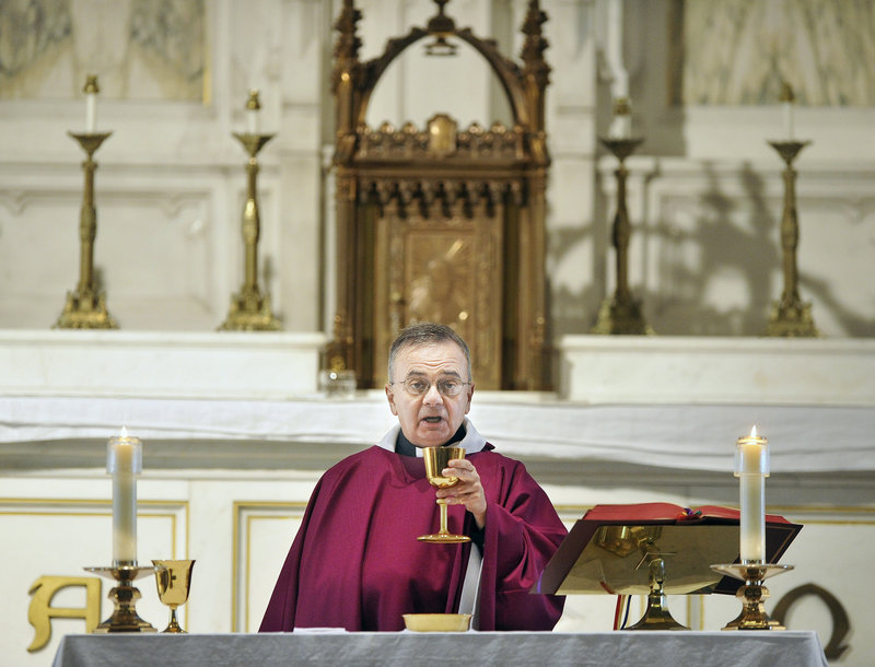 The Rev. Michael Seavey celebrates Mass for parishioners at the Cathedral of the Immaculate Conception in Portland on Thursday afternoon. For his Sunday homily, he said, “the bottom line has got to be hope.”