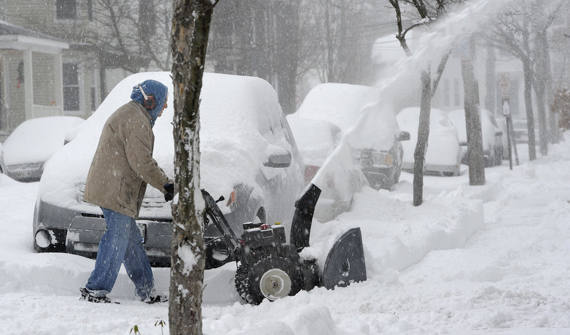 John Pitcher clears his own driveway and also helps out his neighbors along Vesper Street in Portland on Thursday.