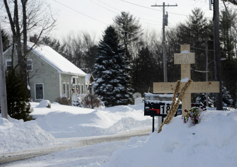 A makeshift memorial stands across from 17 Sokokis Road in Biddeford, where Derrick Thompson and Alivia Welch were shot dead Saturday.