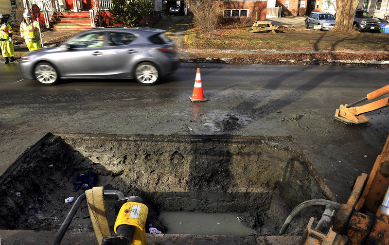 Crews work to repair a water main break on Dartmouth Street in Portland on Dec. 20.