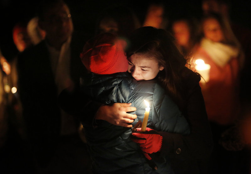 Maria McKeown of Biddeford embraces her aunt Carol LaMontagne of Biddeford at the vigil.