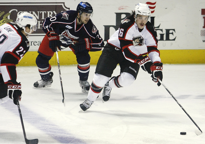 Darian Dziurzynski of the Pirates chases the puck while being trailed by Springfield’s Ryan Russell in the first period Wednesday night at the Cumberland County Civic Center. The Pirates won 3-2, extending their winning streak to six.