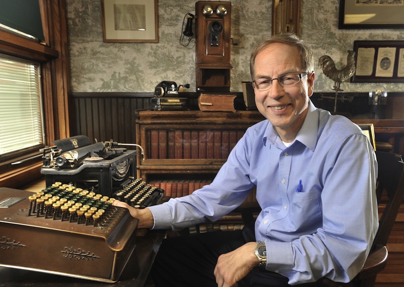 In this 2011 file photo, Peter Geiger of Geiger Promotional Products, publisher of the Farmers Almanac, sits in front of business items from the companies early days. The book of jokes, tips and forecasts has lost some usefulness, but still has its nostalgic appeal.