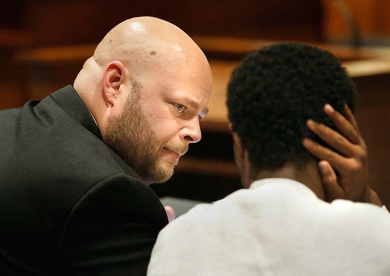 Tim Greenway/Staff Photographer: Mohammed Mukhtar's defense attorney Jonathan Berry talks with his client during a juvenile court hearing on whether to prosecute Mukhtar as an adult or a juvenile in the Cumberland County Unified Criminal Court in Portland on Monday afternoon January 14, 2013. Mukhtar is accused of breaking into a stranger's apartment and raping a woman as she slept.