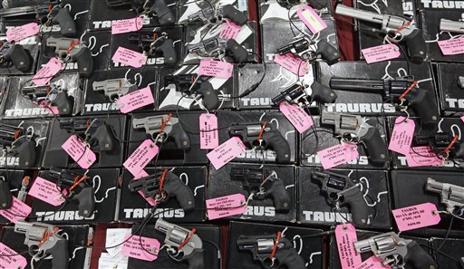 Handguns are displayed during the Rocky Mountain Gun Show in Sandy, Utah, on Jan. 6. The “gun show loophole,” which lifts the background check mandate if the seller is not a licensed firearm dealer, allows more guns to end up on the black market and in the hands of criminals.