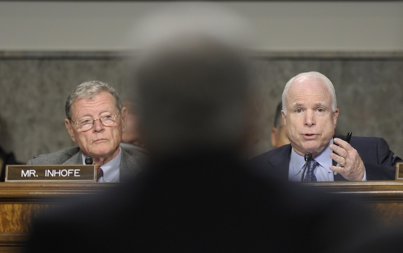 Sen. John McCain, R-Ariz., right, asks a question of former Nebraska Sen. Chuck Hagel, center, President Barack Obama's choice for defense secretary, on Capitol Hill in Washington, Thursday, Jan. 31, 2013, during the Senate Armed Services Committee hearing on his nomination. Sen. James Inhofe, R-Okla., the ranking member of the committee, listens at left. (AP Photo/Susan Walsh)