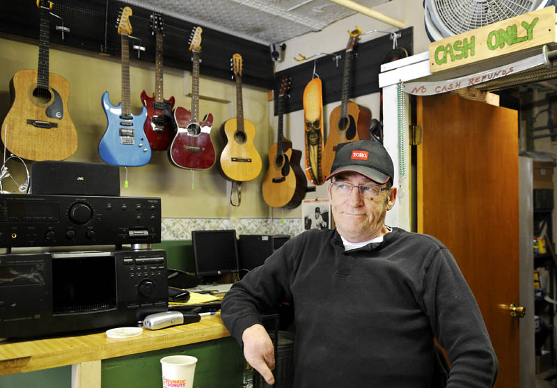 Lonnie Babb waits for a customer Wednesday at the Gardiner Trading Post, the pawn shop he operates. Babb is opposed to a proposed legislation that will put more restrictions on pawn shops.