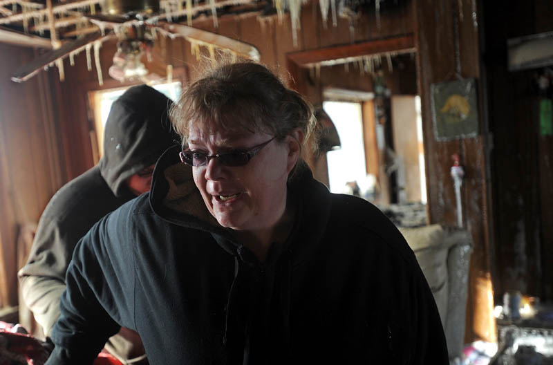 A tear streams down Becky Williams' cheeck as she tours tour what's left of her parents' Madison Avenue, Madison home, with her son Cole, 16.