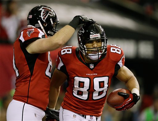 Atlanta Falcons' Tony Gonzalez (88) is congratulated by Michael Palmer after his 10-yard touchdown catch during the first half of the NFL football NFC Championship game against the San Francisco 49ers Sunday.