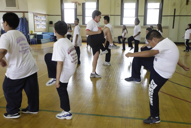 In this May 26, 2009 file photo, Betty Hale, center, instructs a physical education class at Eberhart Elementary School in Chicago. Conventional wisdom says school gym classes make a big difference in kids' weight. But a report in the New England Journal of Medicine, which goes on sale Thursday, Jan. 31, 2013, says this is one of many myths that are detracting from real solutions to the nation's weight problems. According to the report, gym classes often are not long, often or intense enough to make much difference. (AP Photo/M. Spencer Green)