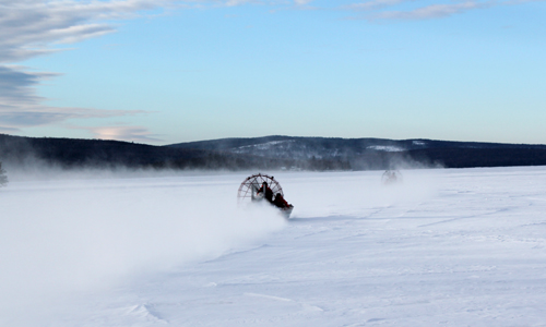 Maine Warden Service airboats drive out toward the open water on Rangeley Lake Thursday morning in search of three missing snowmobilers who are presumed dead.