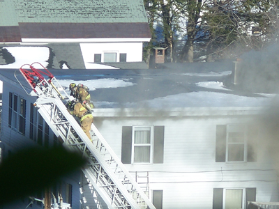 Photo courtesy of Cassie Chase Firefighters battle a blaze Thursday afternoon at 55 Sewall St., Augusta, near St. Michael School.