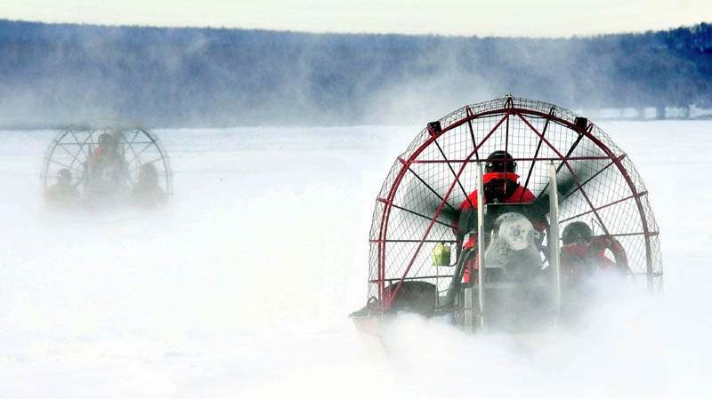 Two Maine Warden Service air boats head out on the ice on Rangeley Lake last week to search for three missing snowmobilers. The Maine Warden Service plans to use a remotely operated underwater vehicle to continue the search for the missing men, who are believed to be dead.